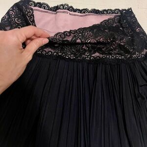 Flowy, black skirt with pink detail lace. Stretch. Size S